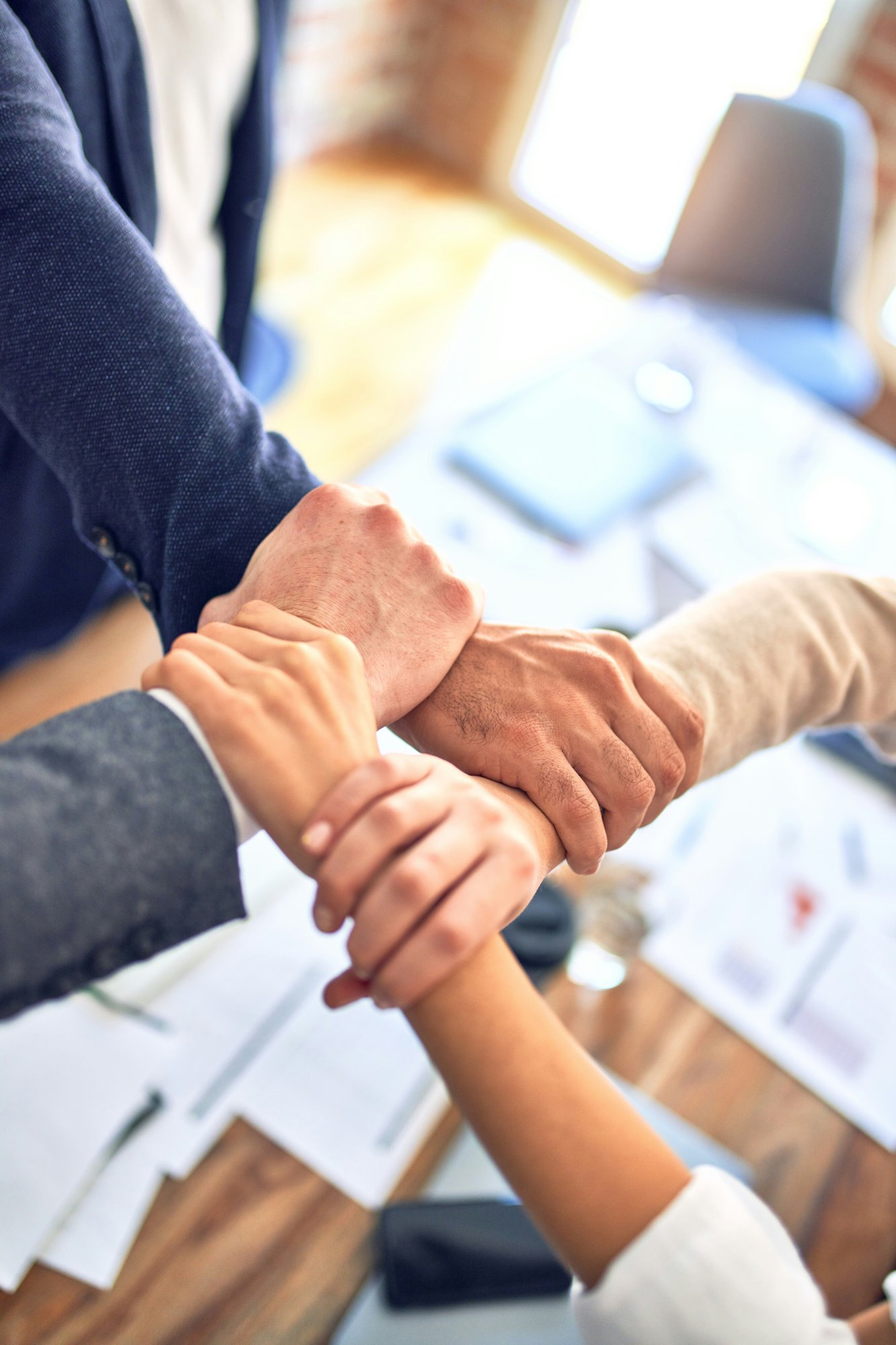Aprendizaje basado en proyectos: un equipo uniendo manos en señal de trabajo conjunto
